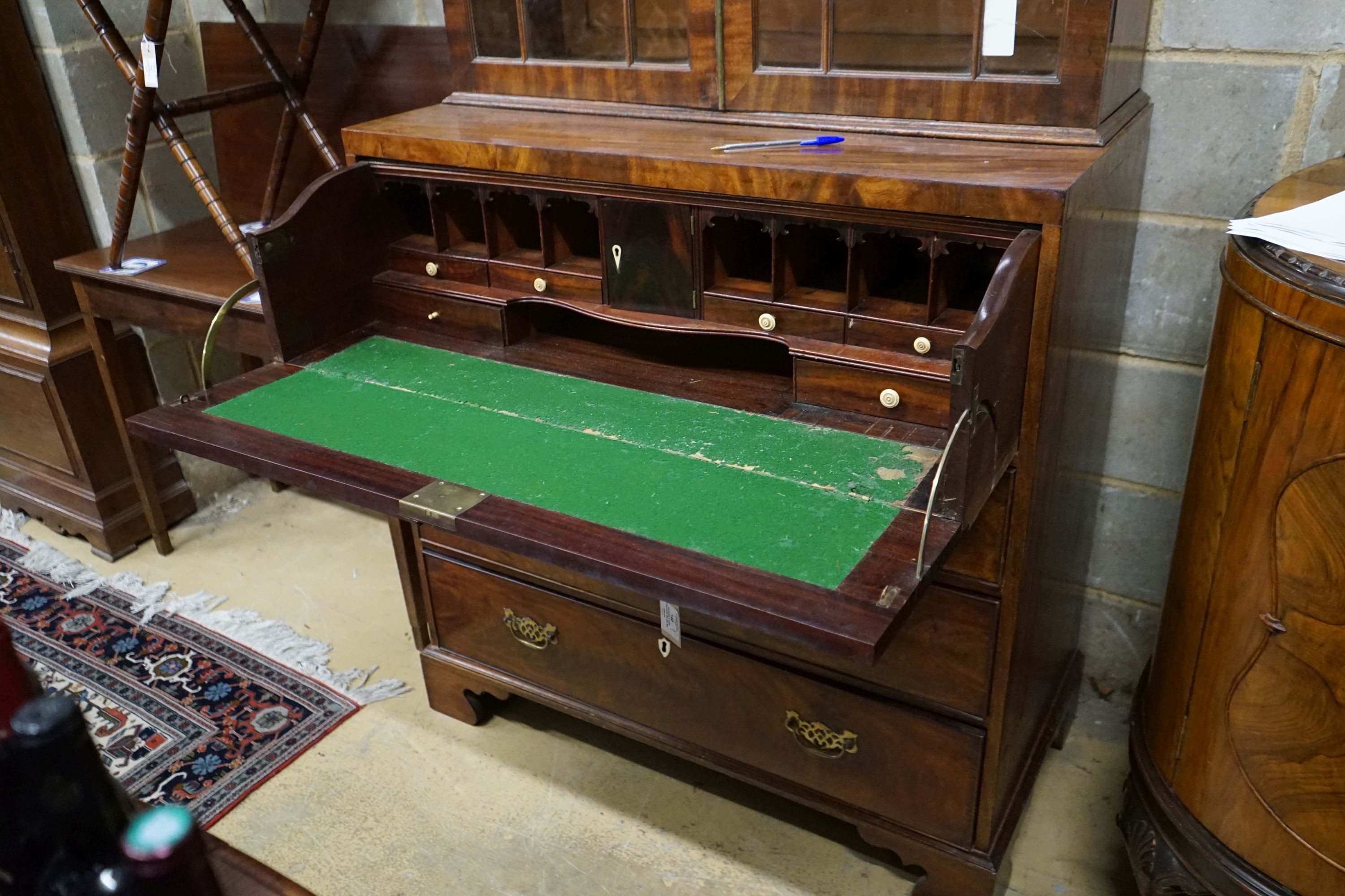 An early 19th century inlaid mahogany secretaire bookcase, length 103cm, depth 53cm, height 221cm